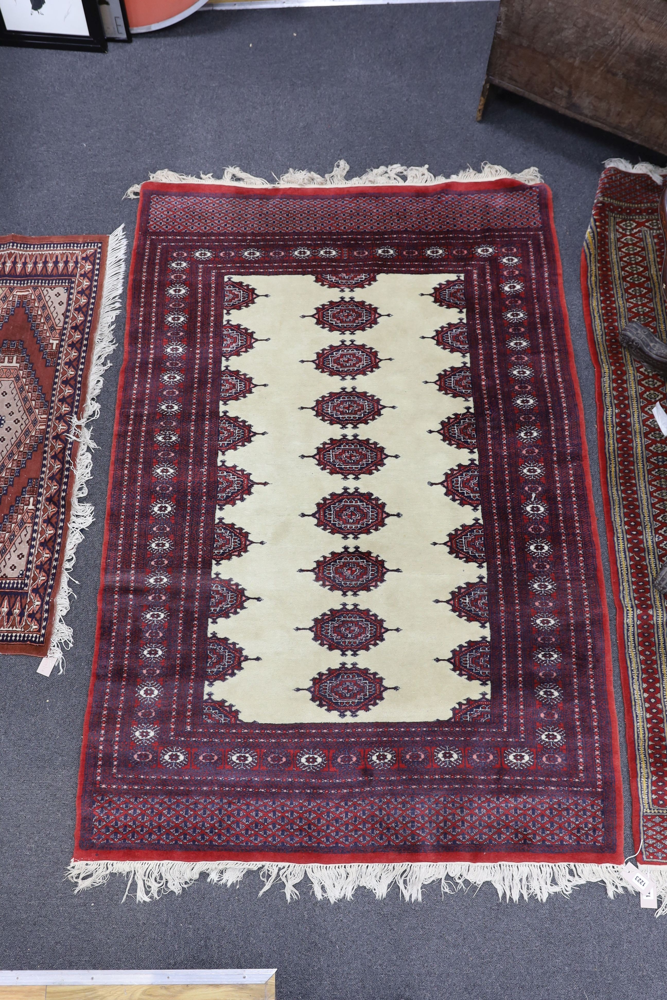 A Bokhara ivory ground rug, 190 x 125cm